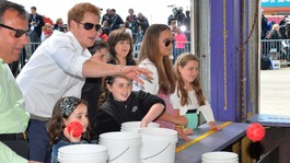 Prince Harry tries his hand at a fairground stall in Mantoloking, a borough of Ocean Heights, New Jersey