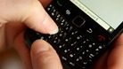 A person writing an instant message on a BlackBerry