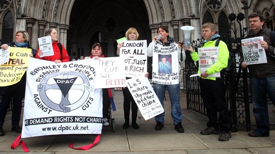 Protesters against the 'bedroom tax' gather outside the Royal Courts of Justice in London.