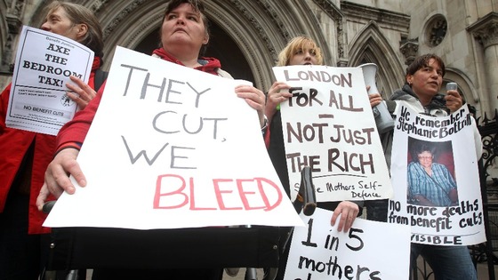 Protesters against the 'bedroom tax' gather outside the Royal Courts of Justice in London.