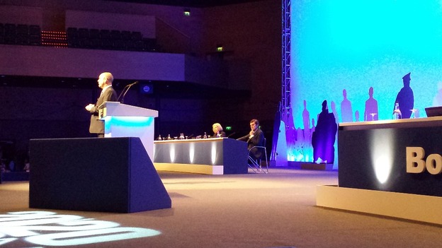 Theresa May listens to Police Federation Chair Steve Williams address the conference