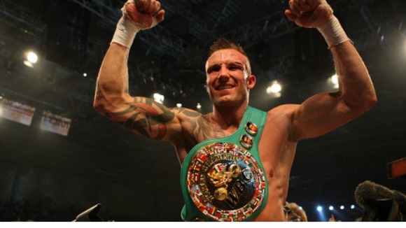 Mikkel Kessler celebrating with the belt after victory over Carl Froch