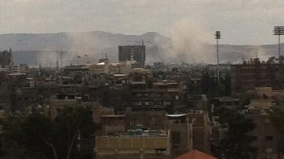 Smoke rises from two hits after a MiG airstrike in Damascus.