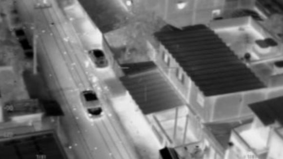 The bullets strewn on the street by a police helicopter are seen illuminated.