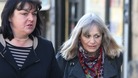 Mrs Marion Giles, 66, (right) walks into the inquest of her husband with her solicitor Mary Ann Charles.
