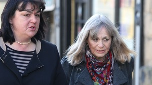 Mrs Marion Giles, 66, (right) walks into the inquest of her husband with her solicitor Mary Ann Charles.