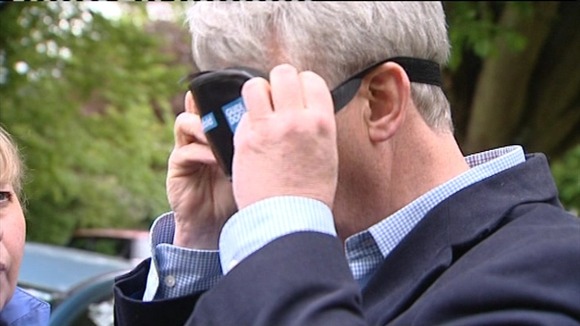 Andrew Lansley putting on a blindfold