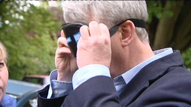 Andrew Lansley putting on a blindfold
