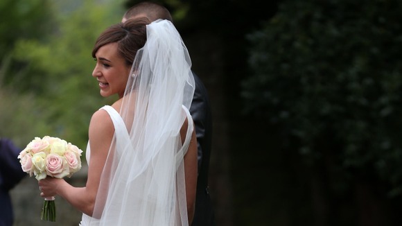 Jessica Ennis shows off her dress for the waiting media after the wedding