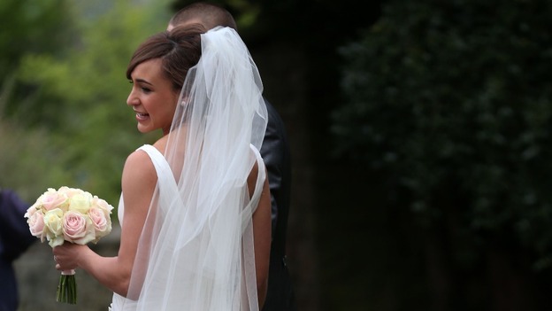 Jessica Ennis shows off her dress for the waiting media after the wedding