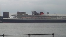 Grey skies as the Queen Mary glides along the Liverpool water front.