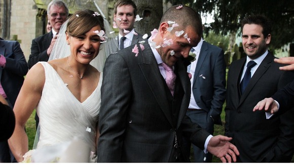 Well-wishers throw confetti at Jessica Ennis and her new husband, Andy Hill.