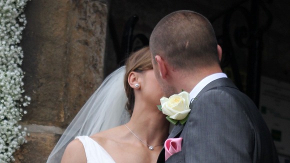 Jessica Ennis and her new husband Andy Hill share a kiss for the cameras.