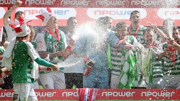 Yeovil Town players celebrate winning promotion to the Championship.
