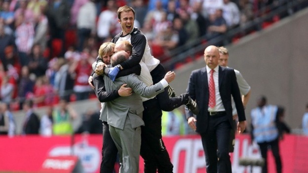 Manager Gary Johnson celebrates with his back room staff.