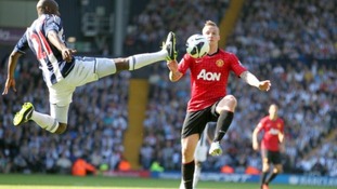 West Bromwich Albion's Youssouf Mulumbu and Manchester United's Alexander Buttner (right) battle for the ball