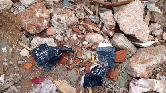 Labels from UK clothing company Premier in the rubble.