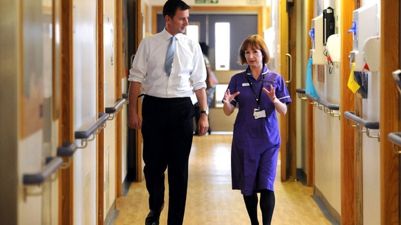 Health secretary Jeremy Hunt is shown around an NHS ward in London.