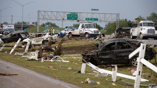 Tow trucks try to clear the road.