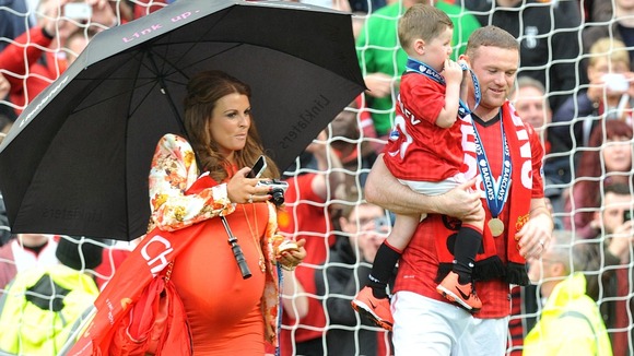 A heavily pregnant Coleen Rooney with husband Wayne Rooney and their son Kai pictured last week.