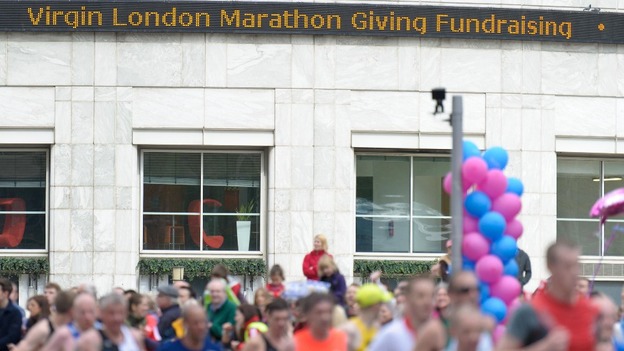 Charity donations replace share prices on the Thomson Reuters LCD ticker tape in Canary Wharf