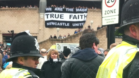 Police monitor the crowds outside St James' Park ahead of the Tyne Wear Derby