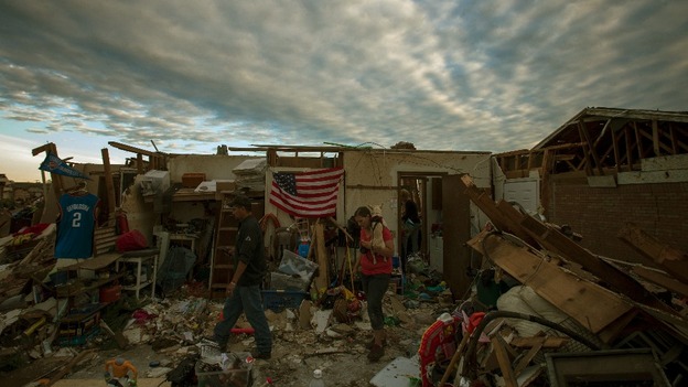 Residents walk through debris of homes after the suburb of Moore, Oklahoma.
