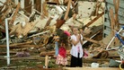 Two girls stand in the rubble after the tornado hits Moore, Oklahoma.