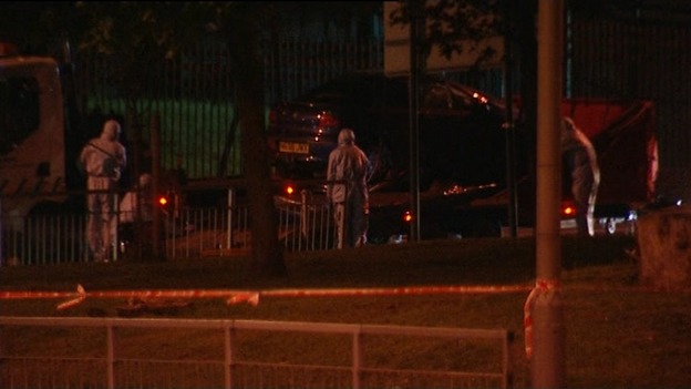Forensic teams move the car from the scene in Woolwich.