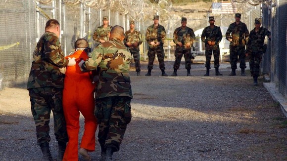 US Army Military Police escort a detainee to his cell at Guantanamo Bay.