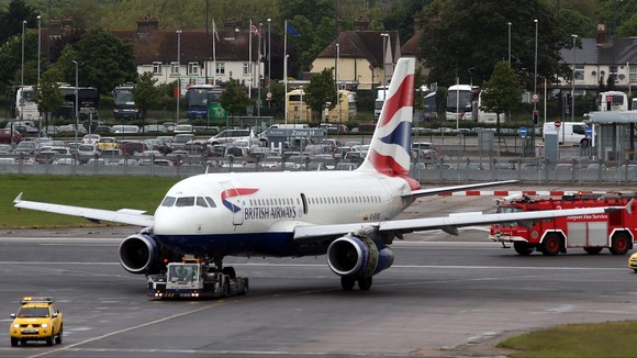 The British Airways plane is towed away after making an emergency landing at Heathrow Airport.