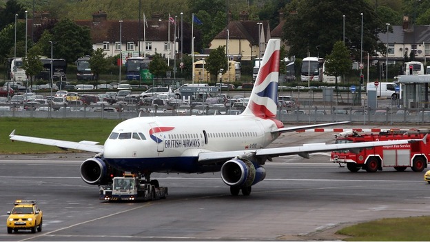 The British Airways plane is towed away after making an emergency landing at Heathrow Airport.