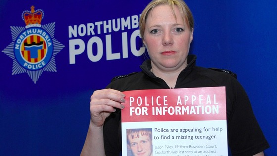 Sgt Leslie Wheatley with one of hundreds of posters, appealing for information.