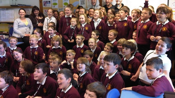 Pupils watch performance by X factor finalist District 3.
