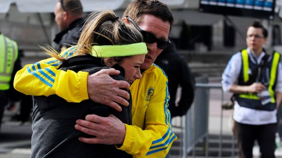 A woman is comforted by a man near a triage tent set up for the Boston Marathon