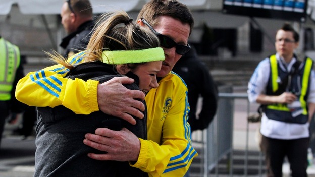 A woman is comforted by a man near a triage tent set up for the Boston Marathon