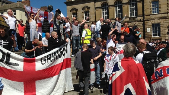 EDL supporters carry St George's flags