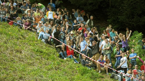 Spectators line the slope of Coppers Hill