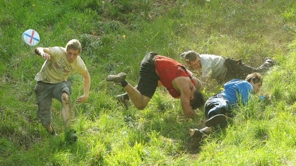 Competitors take part in the annual Cheese Rolling event at Coppers Hill near Brockworth, Gloucestershire
