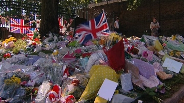 People lay flowers at the scene