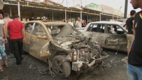 A car damaged in one of the blasts in Nasr Square, Iraq