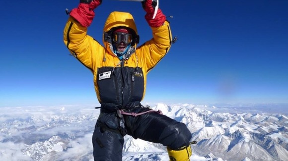 Dr Adam Booth at the top of Everest.