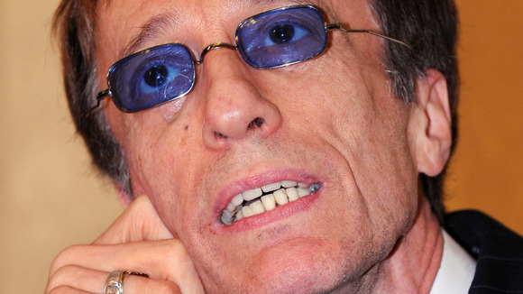 Robin Gibb awakes from a coma after contracting pneumonia in his battle against cancer