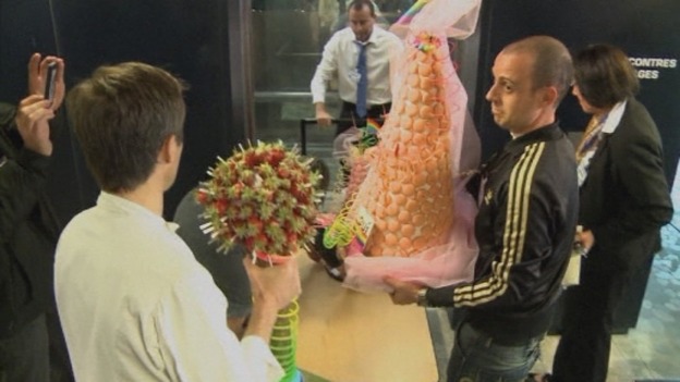 One of the two cakes is moved onto a trolley at the Montpellier city council building