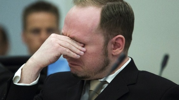 Norwegian mass killer Breivik cries as he watches a video presented by the prosecution during his trial