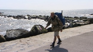 Former soldier Christian Nock walking along the coast at Lowestoft