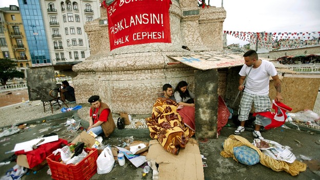 Demonstrators rest in Taksim Square where police and anti-government protesters clashed through the night. 