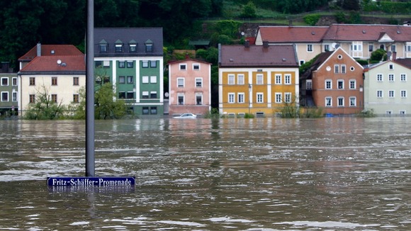 street sign is partially submerged in the flooded centre of the Bavarian town of Passau,