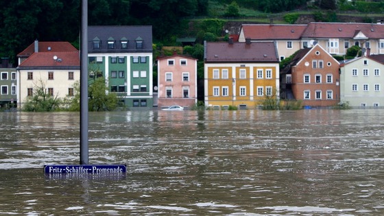 street sign is partially submerged in the flooded centre of the Bavarian town of Passau,
