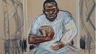 Michael Adebolajo sits in the dock holding a copy of the Koran.